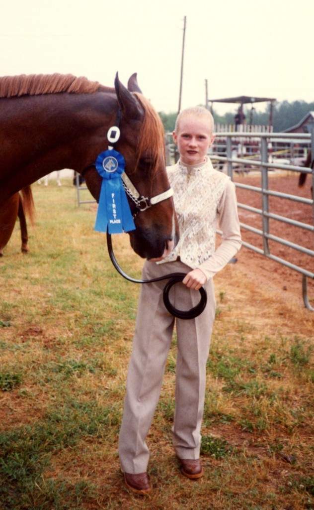 Hannah at 11 years old with her horse, Monster.